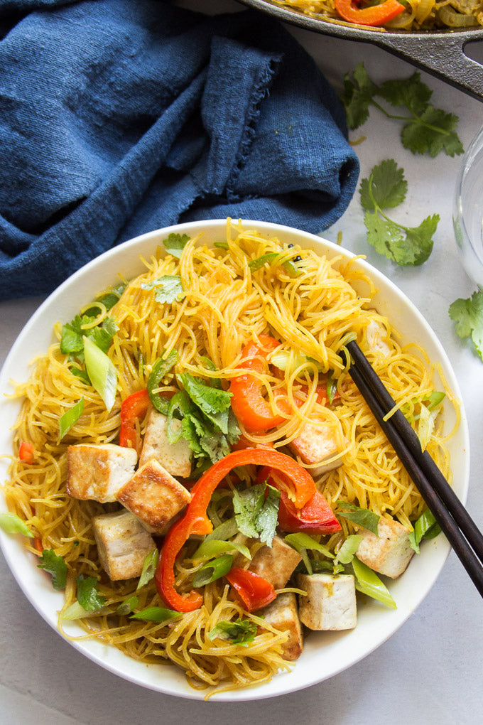 These Singapore noodles are better than takeout and almost as easy! Made with crispy stir-fried rice noodles in curry sauce with veggies and pan-fried tofu, this flavorful dish might just be your new favorite weeknight dinner.
